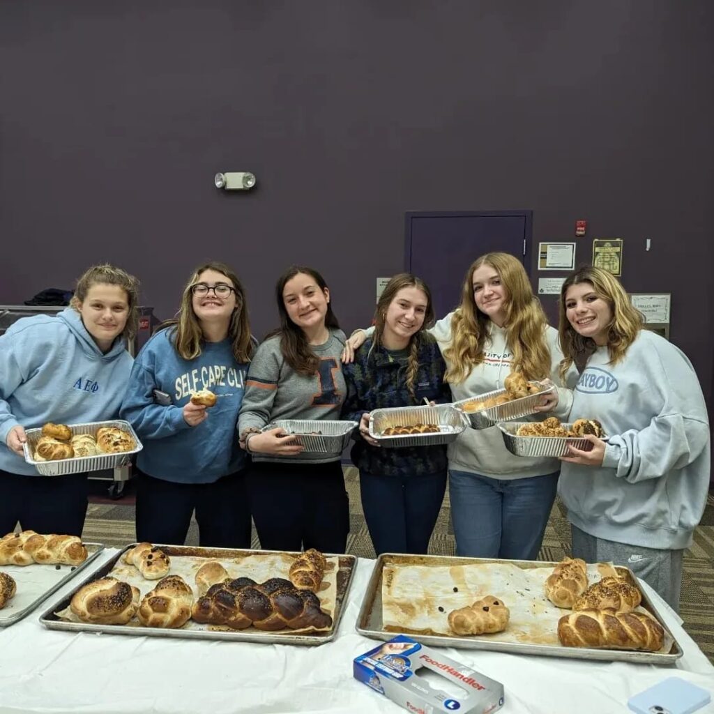 Members of the University of Illinois Urbana-Champaign’s Jewish Learning Initiative on Campus (JLIC) showing off the challahs they made at the event