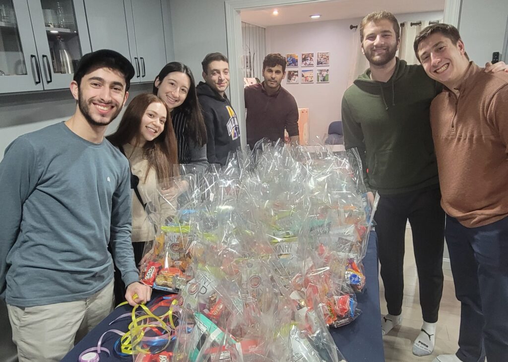 The Brandies JLIC community preparing the mishloach manot packaged for the Purim crossover story