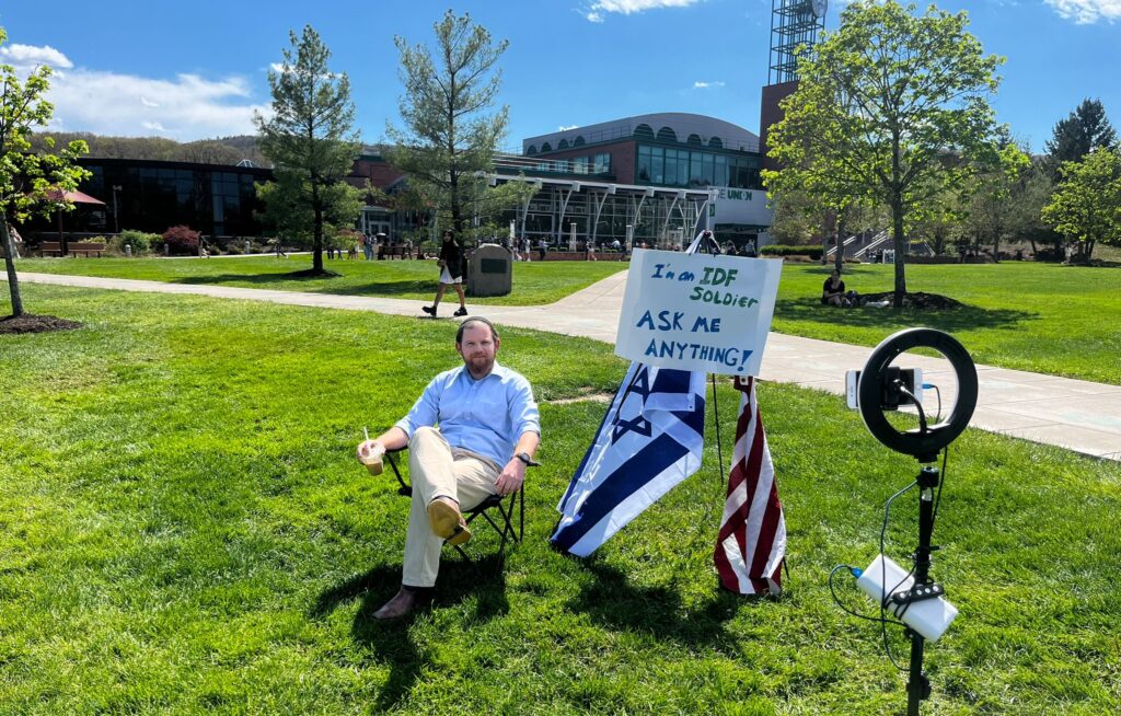 Rav Ben Menora set up on campus with his Ask Me Anything stand to help students understand the issues in Israel and how the IDF is a moral army defending their citizens. 