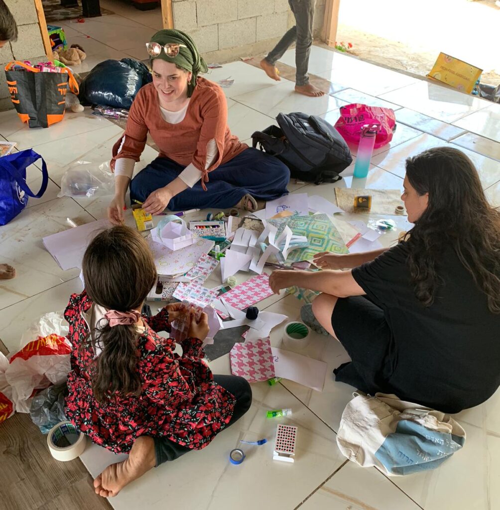 Members of the JLIC Tel Aviv Community doing arts and crafts with one of the Husseini girls.