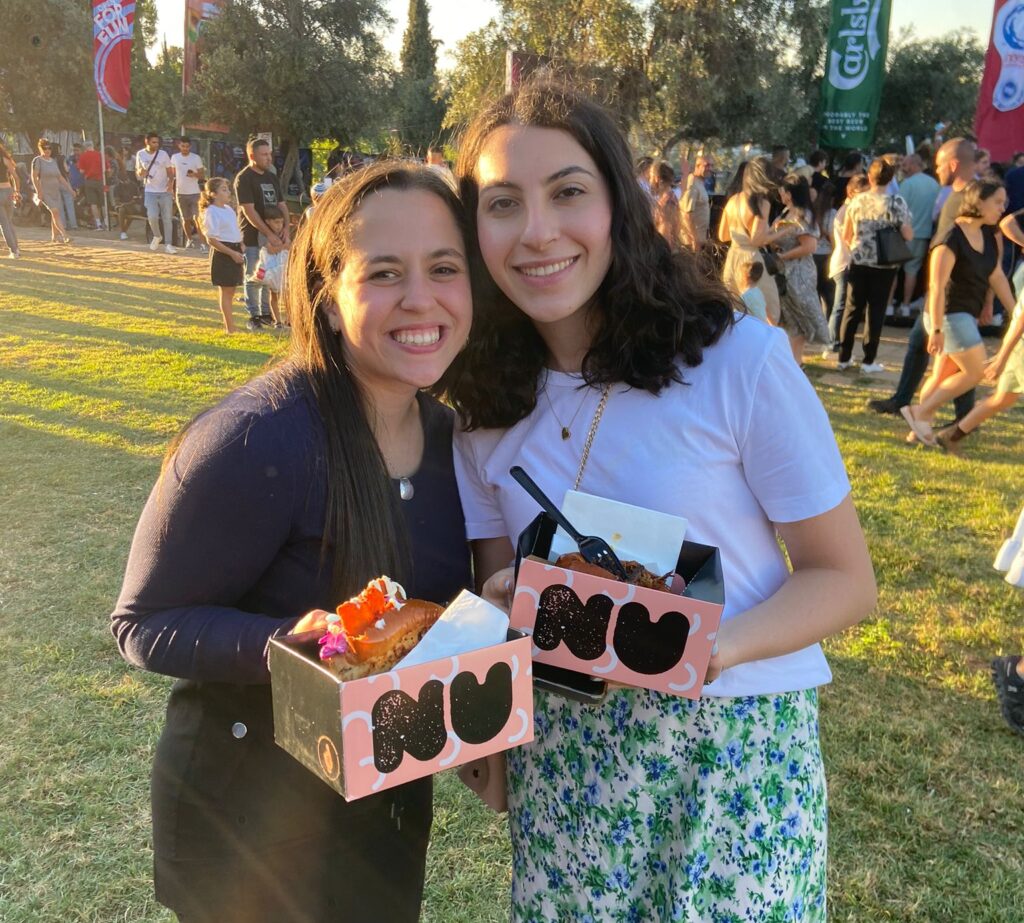 Two students from the JLIC Summer program at Harova enjoying their evening at the Jerusalem food festival. 