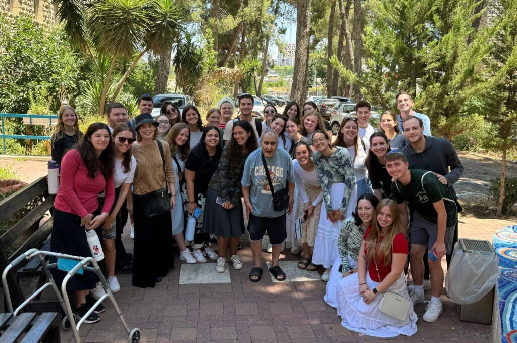 The group posing with some of the people they volunteered with during their trip.