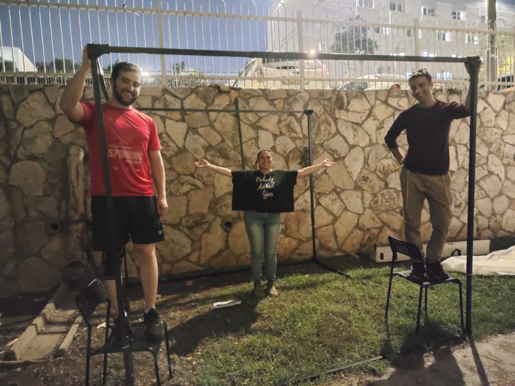 JLIC community members after the sukkah frame is up.