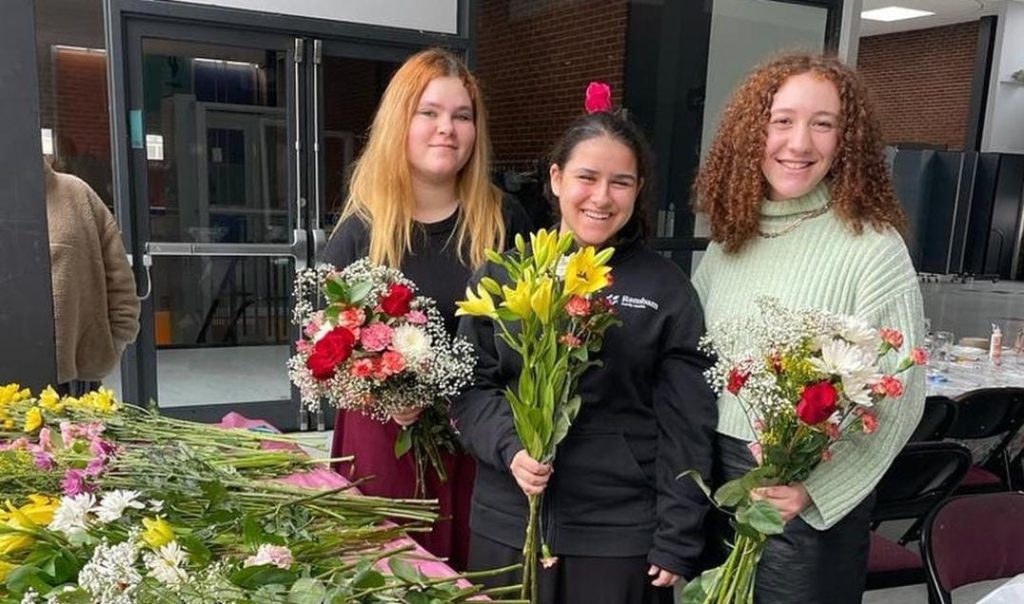 JLIC Brooklyn College Women at a social event making flower arrangements. 