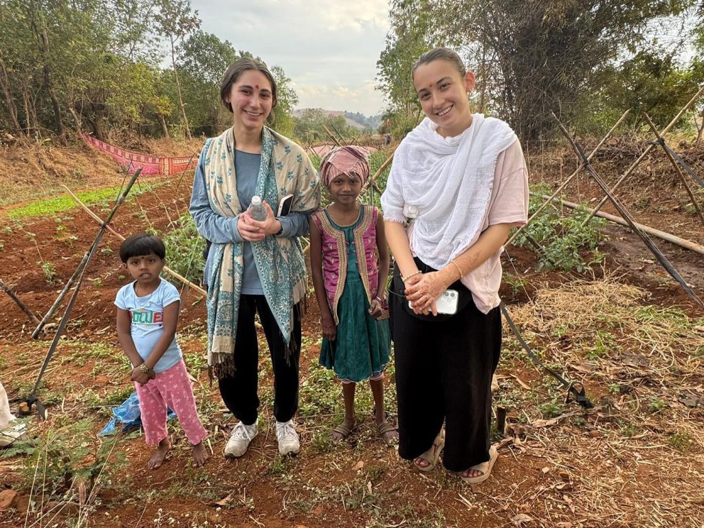 JLIC Rutgers students during their Sustainability Efforts: Painting trees with a protective lime and blue copper mixture to prevent pest infestations and secure crops.