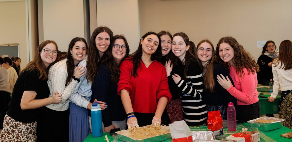 Girls from the Winter Mission baking challah with Yachad