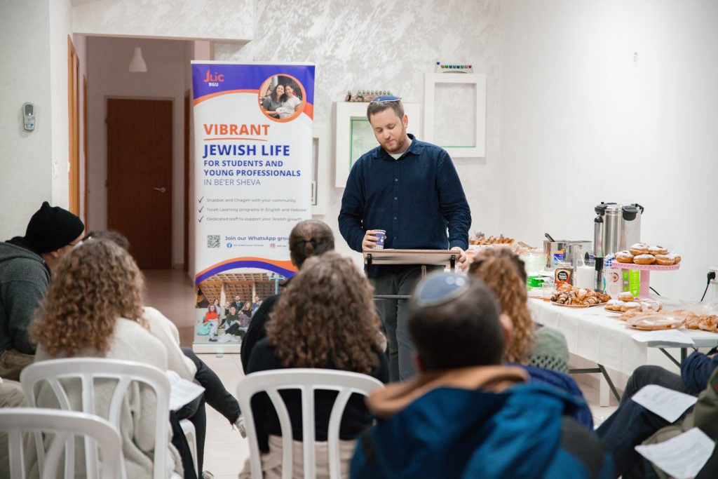 A BGU JLIC student giving their TED talk style Chanukah presentation 