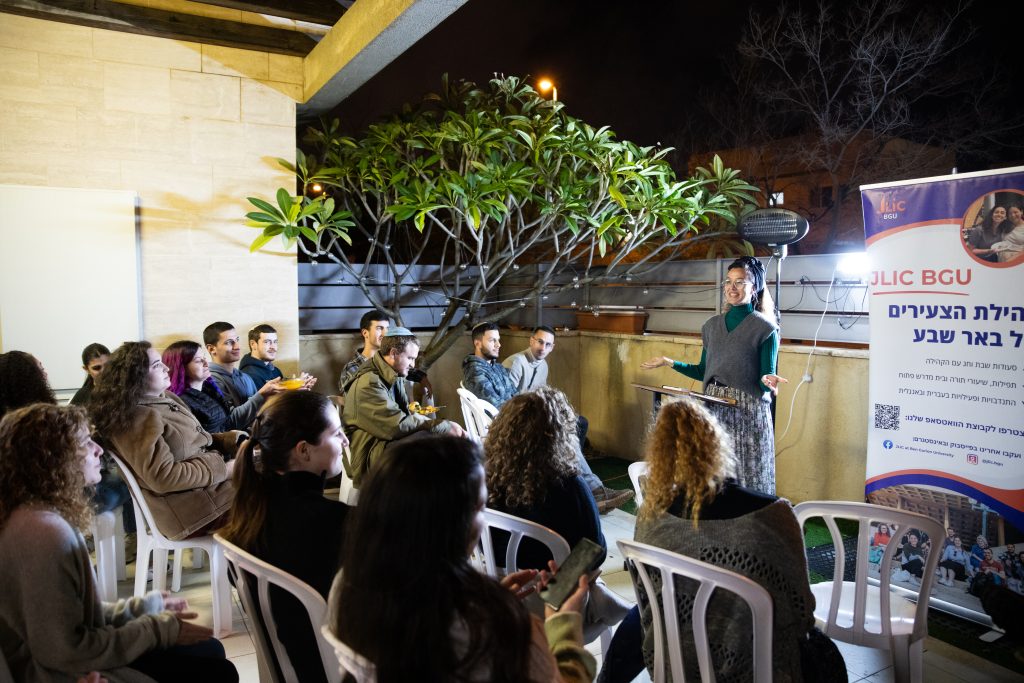 A BGU JLIC student giving their TED talk style Chanukah presentation 