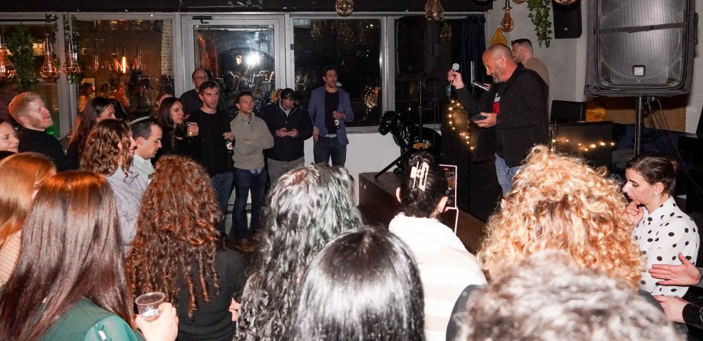 A member of Kibbutz Nir Am speaking to the Tel Aviv JLIC community at their annual Chanukah party.