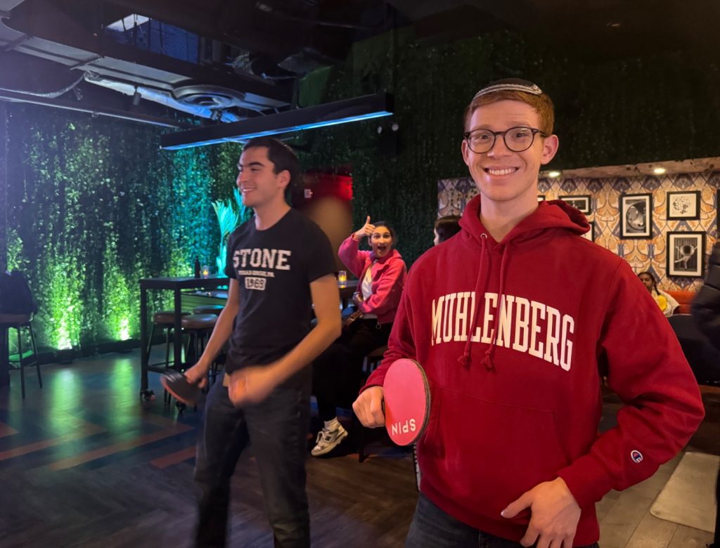 Yavnen LEAD fellows playing Ping-Pong at their post shabbat event