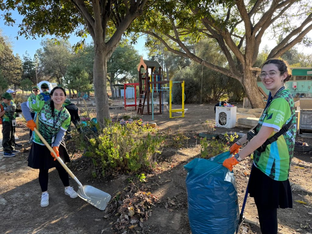 Yavneh Fellows helping clean up a park during their alternative winter break trip to Israel 