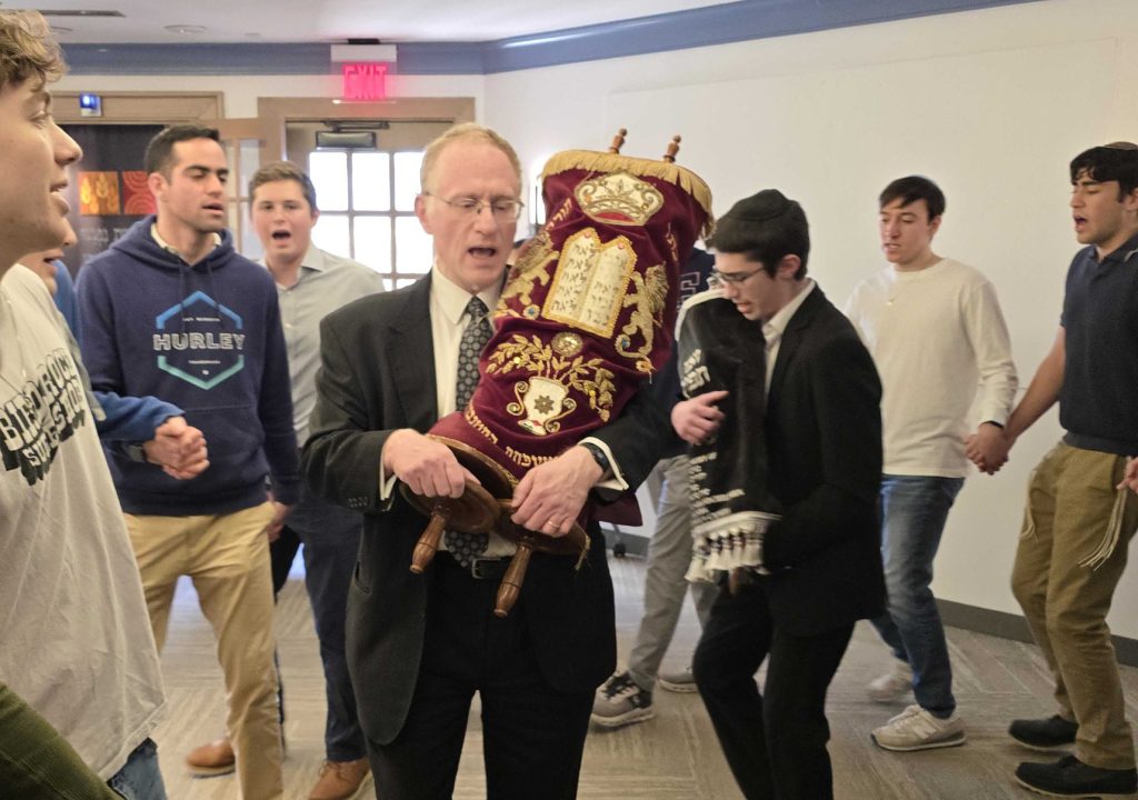 Princeton University JLIC students and Mr. Sipes welcoming in the new Torah 