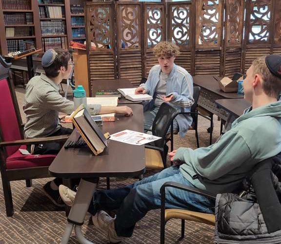 Men learning together in a pod at Rutgers University